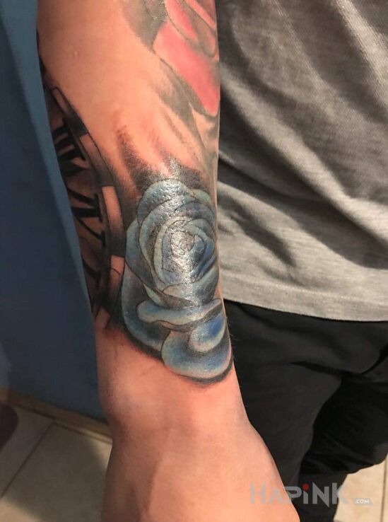 Tattoo Róża! in colorful motif on the forearm