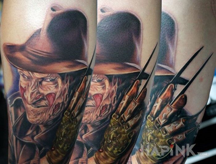 Tattoo Freddie Kruger 5 in faces motif on the upper arm