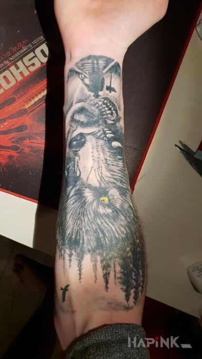 Tattoo Wilki i las in animals motif on the forearm