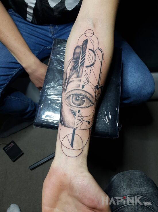 Tattoo Hamsa hand in religious motif on the forearm