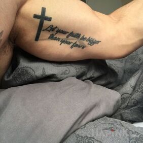 Tattoo Faith on the upper arm motif: religious
