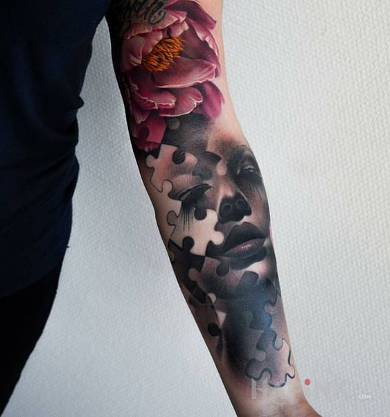 Tattoo Puzzle in flowers motif on the forearm