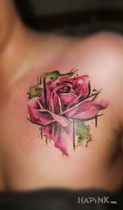 Tattoo Rose in colorful motif and Watercolor style on the collarbone