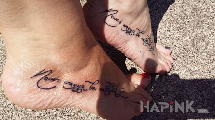 Tattoo Never wanna be without you in lettering motif and calligraphy style on the foot