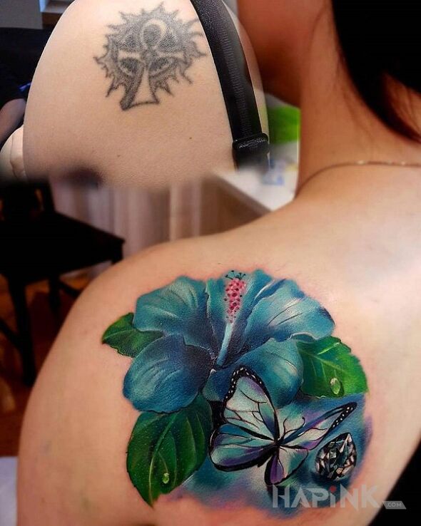 Tattoo Niebieski kwiat in butterflies motif and realistic style on the shoulder blades