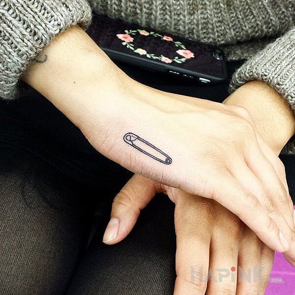 Tattoo Agrafka in objects motif and minimalistic style on the hand