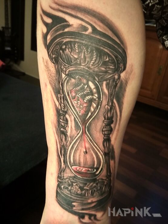 Tattoo Klepsydra in objects motif and realistic style on the calf
