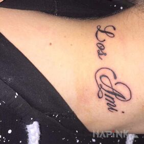 Tattoo Los Ami on the neck motif: lettering style: calligraphy