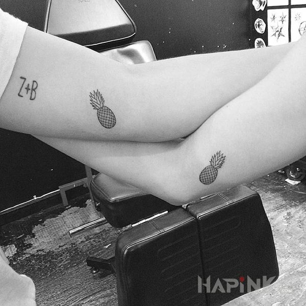 Tattoo Ananaski in Love motif and minimalistic style on the upper arm