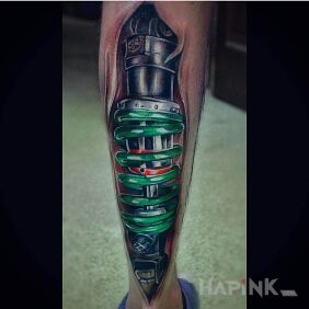 Tattoo Green spring on the calf motif: motorization style: biomechanics