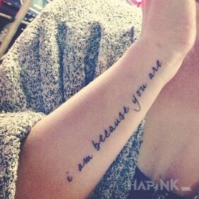 Tattoo Why am I? on the forearm motif: lettering style: calligraphy