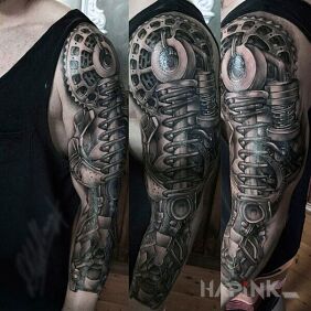 Tattoo Springs in the paw on the upper arm motif: black and gray style: biomechanics