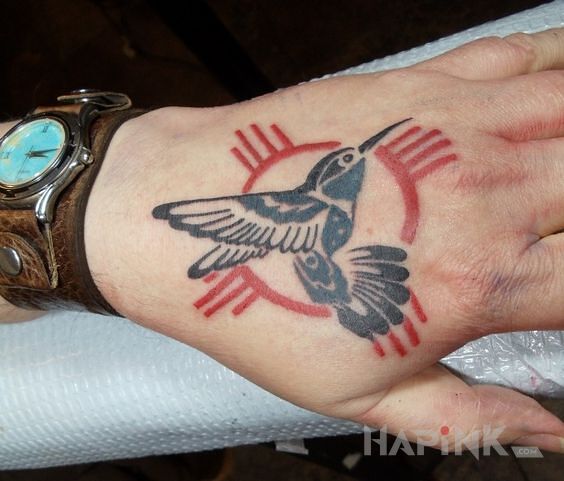 Tattoo Koliber in animals motif and graphic / illustrative style on the hand