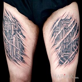 Tattoo Mechanical thighs on the leg motif: black and gray style: biomechanics