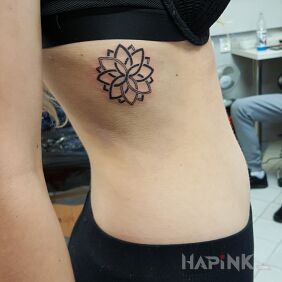Tattoo Geometric flower on the ribs motif: black and gray style: geometric