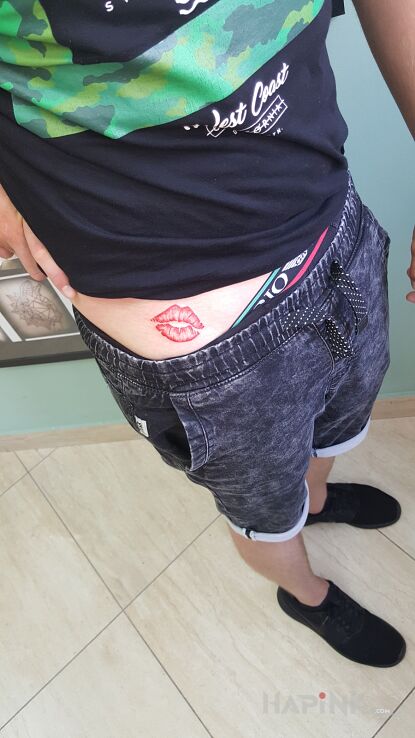 Tattoo Usta in colorful motif and graphic / illustrative style on the stomach