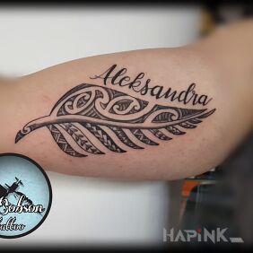 Tattoo Polynesian fern leaf with name on the upper arm motif: black and gray style: Polynesian