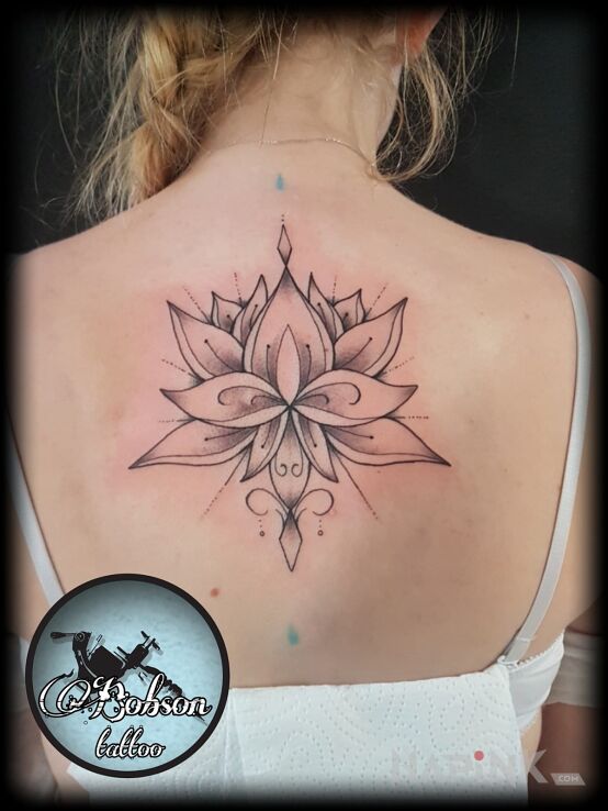 Tattoo Lotos in flowers motif and graphic / illustrative style on the back