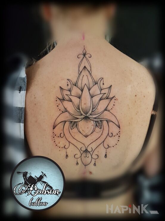 Tattoo Lotos in black and gray motif and graphic / illustrative style on the back