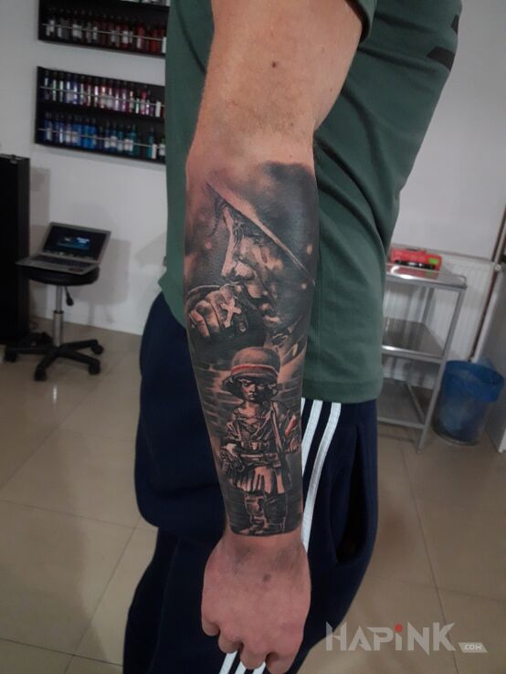 Tattoo Powstaniec in faces motif and realistic style on the forearm