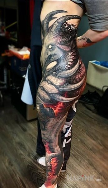 Tattoo Rogata bestia in colorful motif and realistic style on the leg