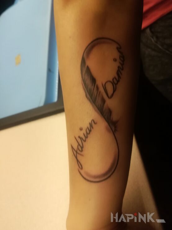 Tattoo Nieskończoność in lettering motif and graphic / illustrative style on the forearm