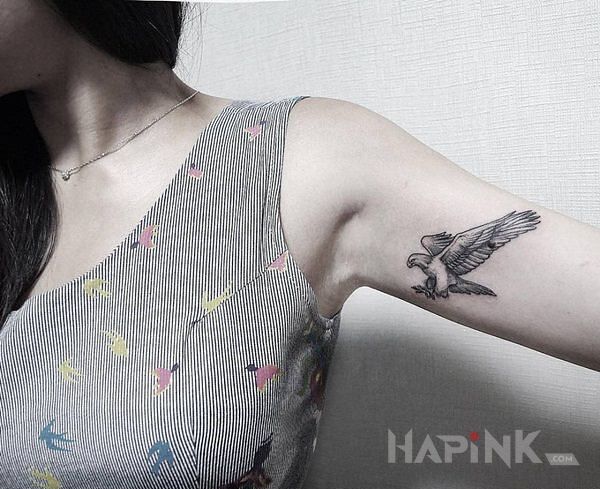Tattoo Orzełek in black and gray motif and graphic / illustrative style on the upper arm