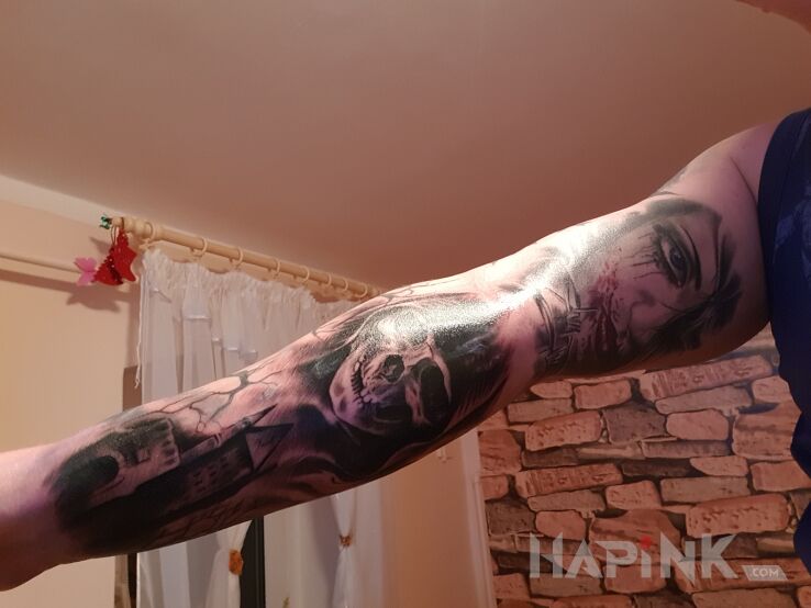Tattoo Czacha in black and gray motif and realistic style on the upper arm