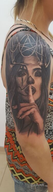 Tattoo Cichosza in black and gray motif and realistic style on the upper arm