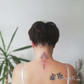 Tattoo ?Jgd on the shoulder blades motif: Indian style: graphic / illustrative