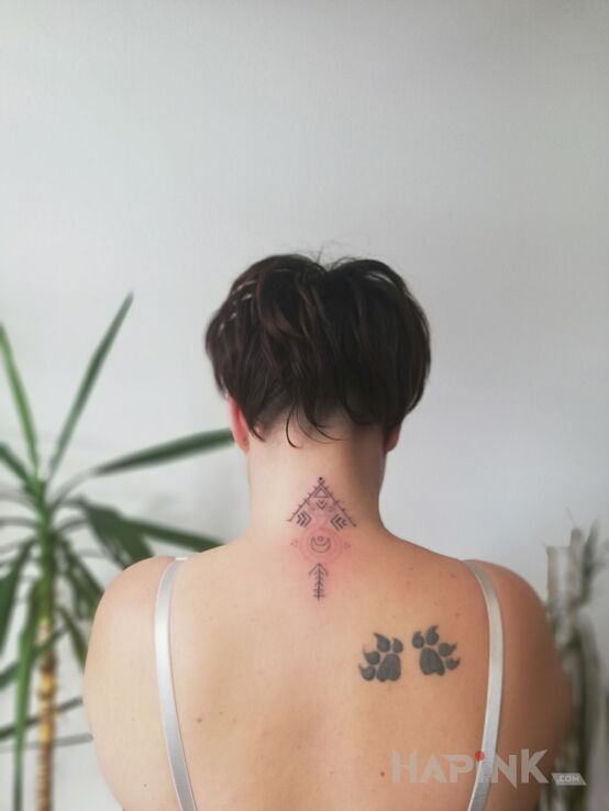 Tattoo ?Jgd in Indian motif and graphic / illustrative style on the nape