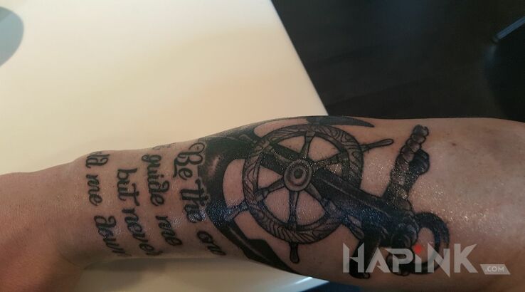 Tattoo Moj pierwszy in black and gray motif and realistic style on the forearm