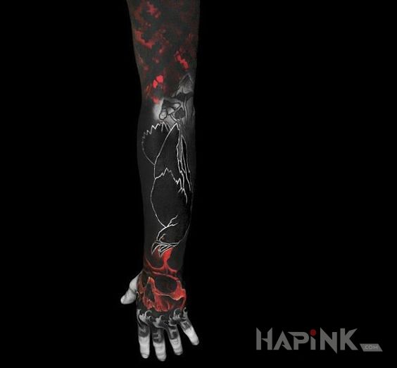 Tattoo Kruczoczarny in animals motif and blackwork / blackout style on the forearm