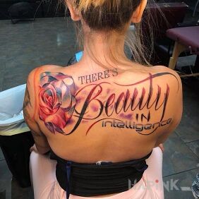Tattoo The beauty of intelligence on the back motif: flowers style: calligraphy