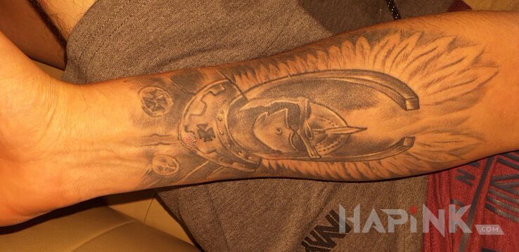 Tattoo Husaria in black and gray motif and graphic / illustrative style on the forearm