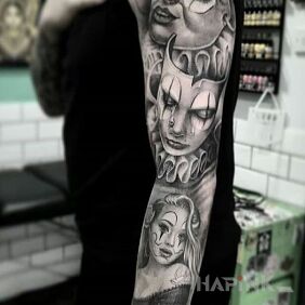 Tattoo Clowns on the forearm motif: black and gray style: realistic