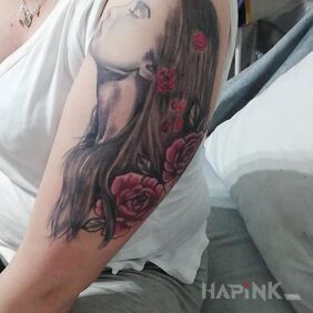 Tattoo Women's tattoo on the upper arm motif: flowers style: realistic