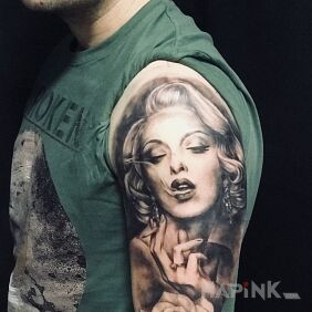 Tattoo Shall we light ? on the upper arm motif: faces style: realistic