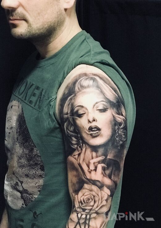 Tattoo Zapalimy ? in black and gray motif and realistic style on the upper arm