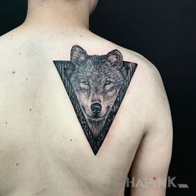 Tattoo Wolf on the shoulder blades motif: black and gray style: realistic