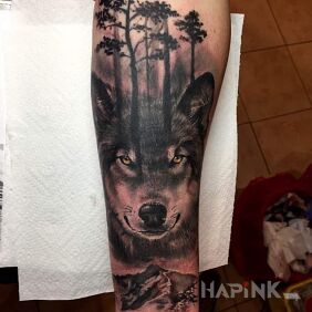 Tattoo Wolf with trees on the forearm motif: animals style: realistic