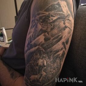 Tattoo Mountain rescue on the upper arm motif: black and gray style: realistic