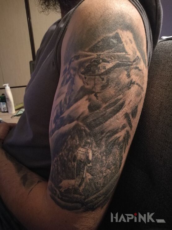 Tattoo Ratownictwo górskie in black and gray motif and realistic style on the upper arm