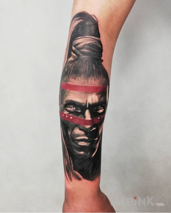 Tattoo Wojownik,przywodca in faces motif and realistic style on the forearm