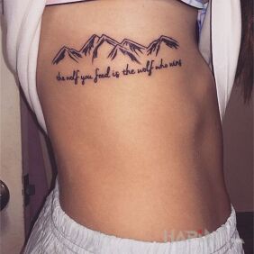 Tattoo Feeding the wolf in you on the ribs motif: lettering style: minimalistic
