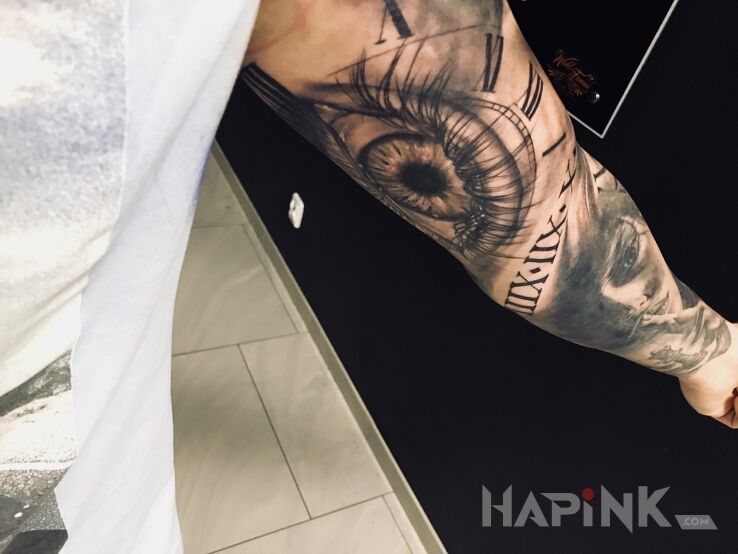 Tattoo Oko in black and gray motif and realistic style on the upper arm