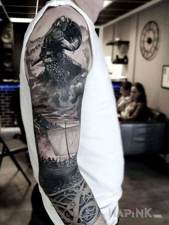 Tattoo Wikings in characters motif and realistic style on the upper arm