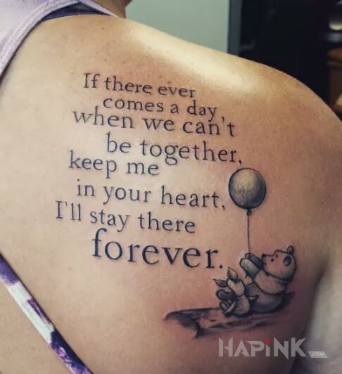 Tattoo Z kubusia puchatka in characters motif and calligraphy style on the shoulder blades