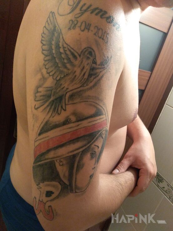 Tattoo Moje życzę in black and gray motif and graphic / illustrative style on the upper arm