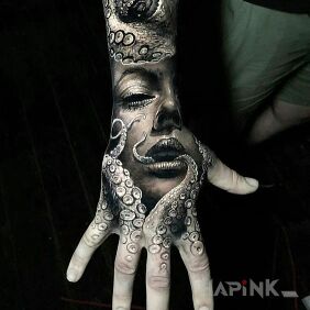 Tattoo In the tentacles on the hand motif: animals style: realistic